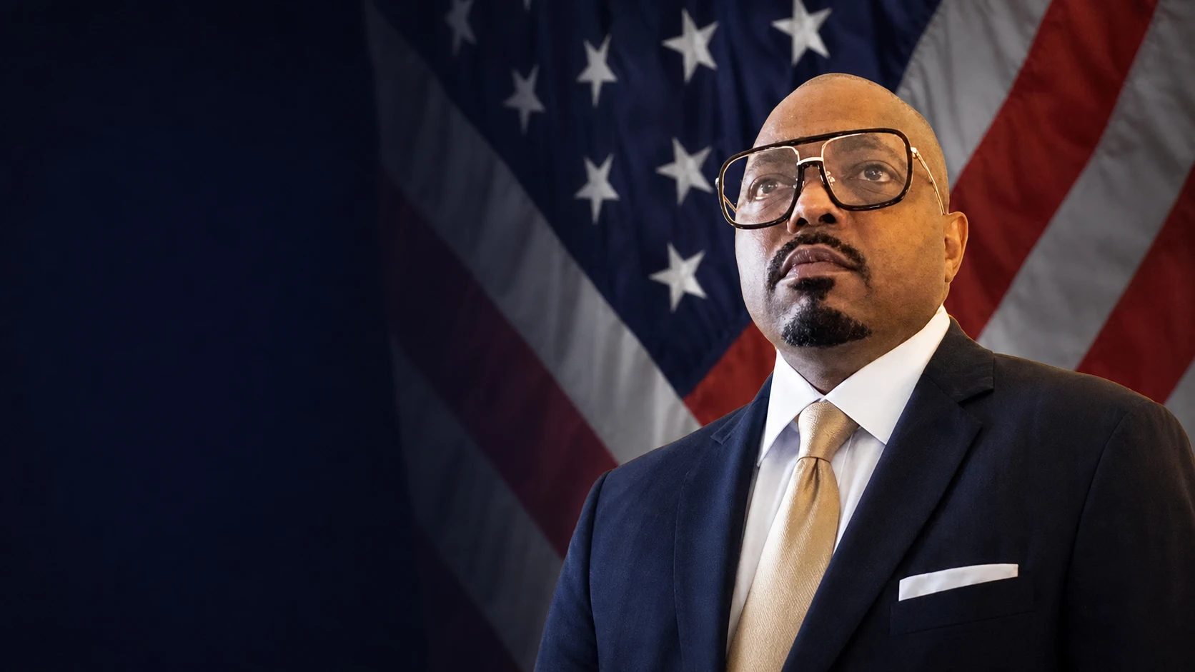 Darius Robinson standing before an American flag